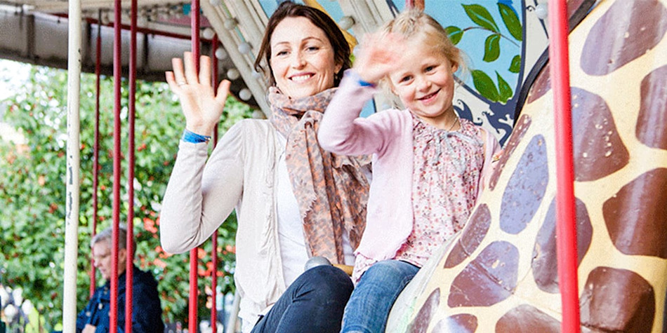 A mother and daughter on a carousel at Tivoli 