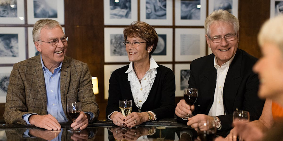 Group drinking wine at onboard bar 