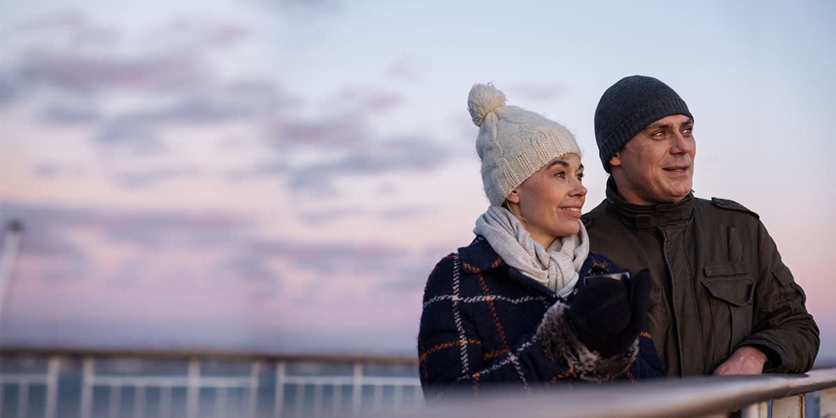 Couple on deck watching the sunset