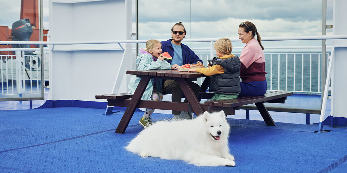 Family on deck with a dog