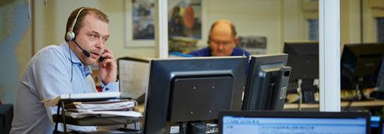 DFDS employees working at computers in a control tower