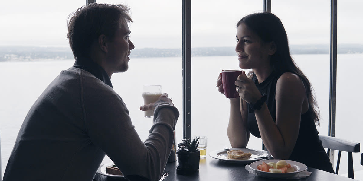 Couple having breakfast on board