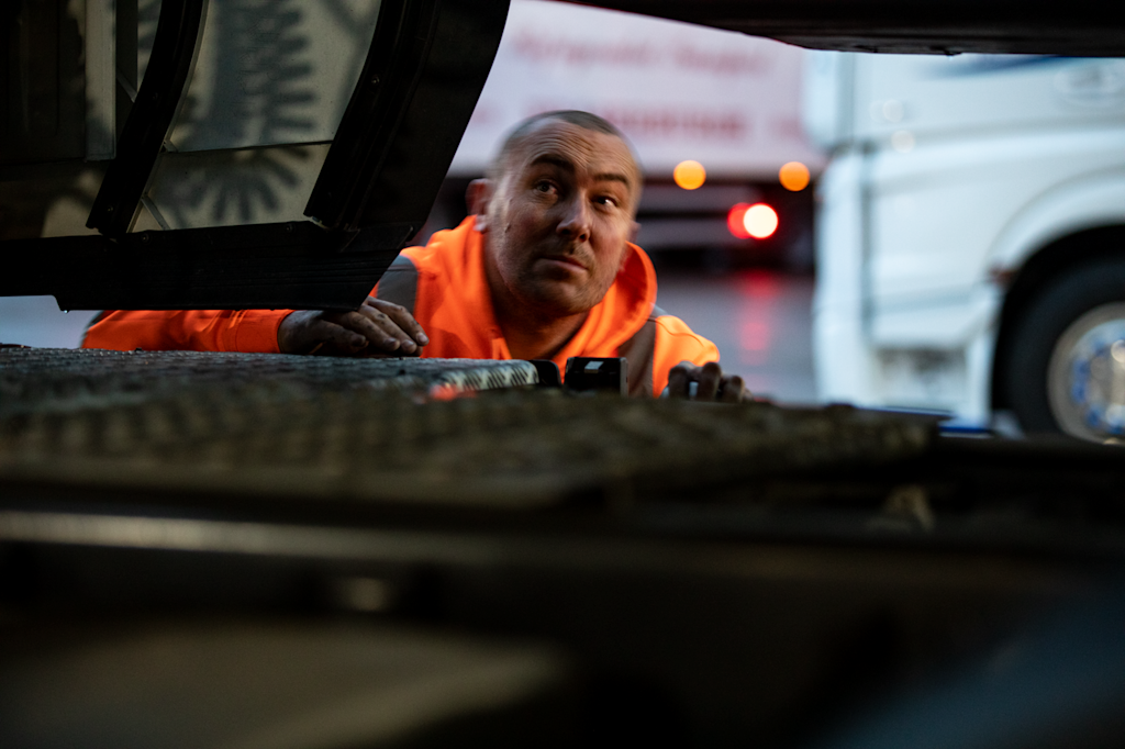 DFDS employee wearing a high visibility jacket looking inside a trailer at a terminal Cold chain employee