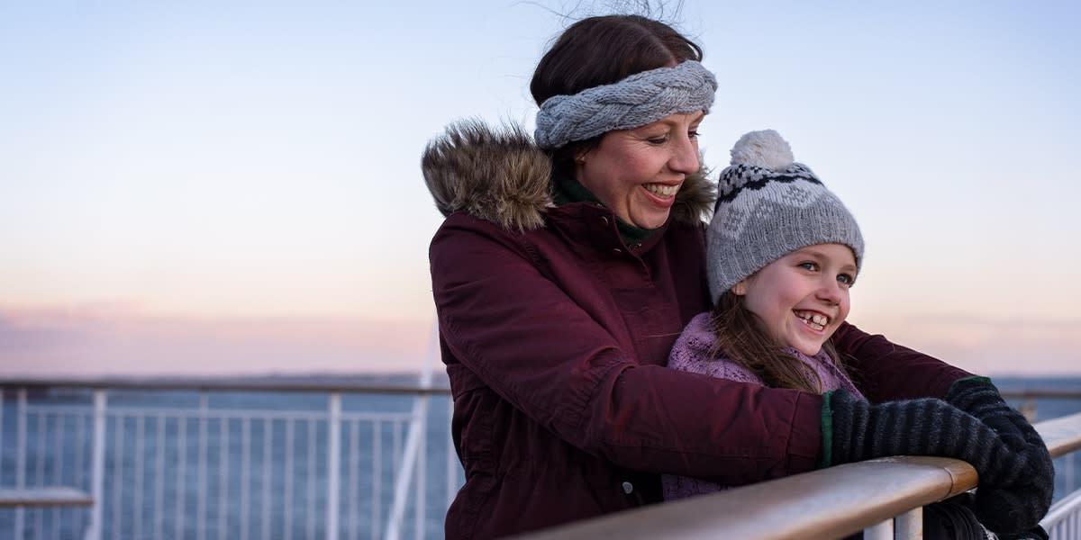Mother and daughter on deck in winter