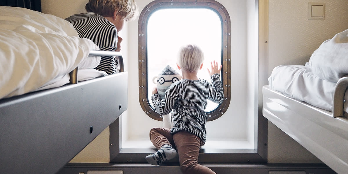 Children looking out of a window onboard