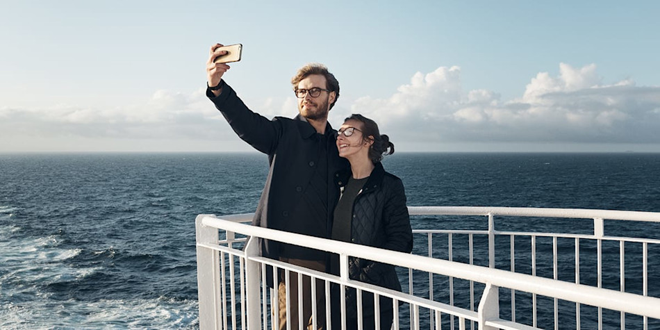 Couple on deck onboard DFDS taking a selfie.