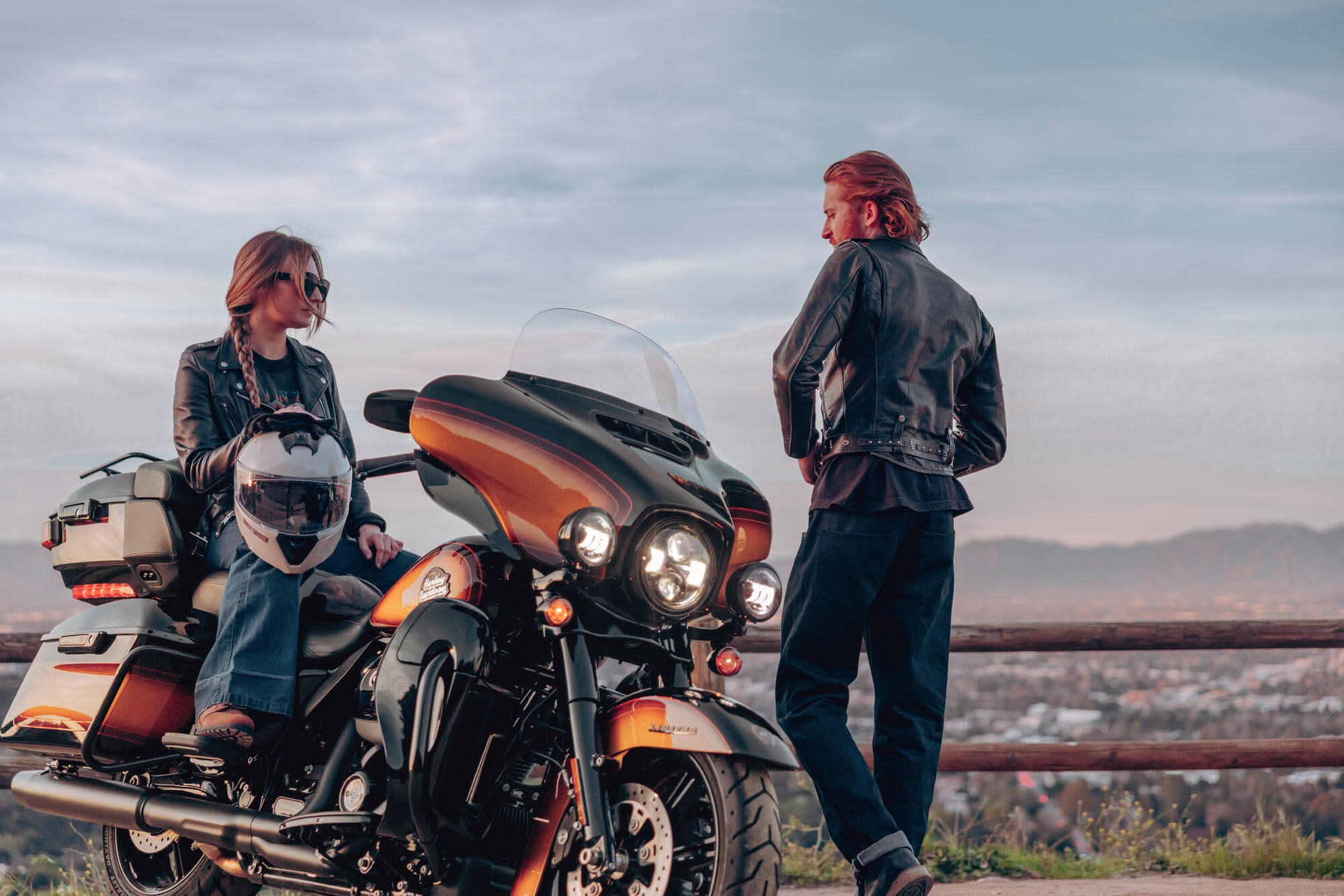 Couple with Harley Davidson motorbike Couple with Harley Davidson motorbike