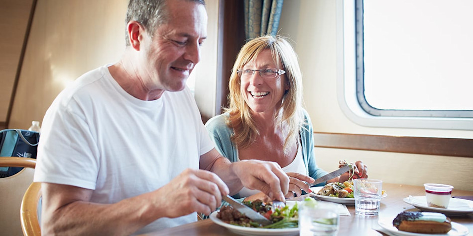 Couple enjoying food in a restaurant onboard DFDS Newhaven- Dieppe ferry.