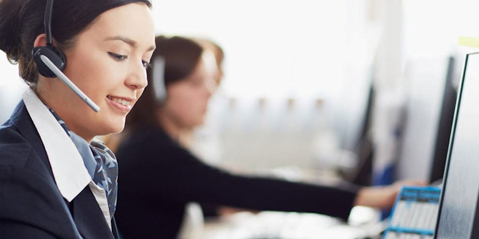 A woman listening to a customer on a headset in the customer service office 
