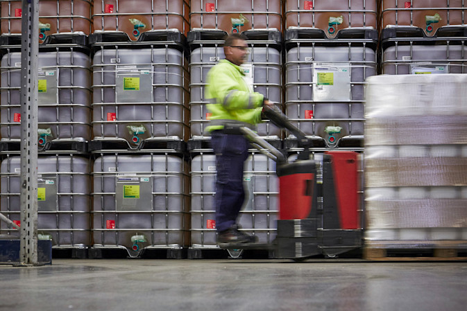 A DFDS Logistics employee moving chemicals inside a warehouse