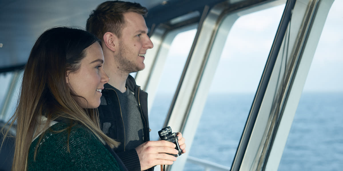 couple onboard watching horizon 