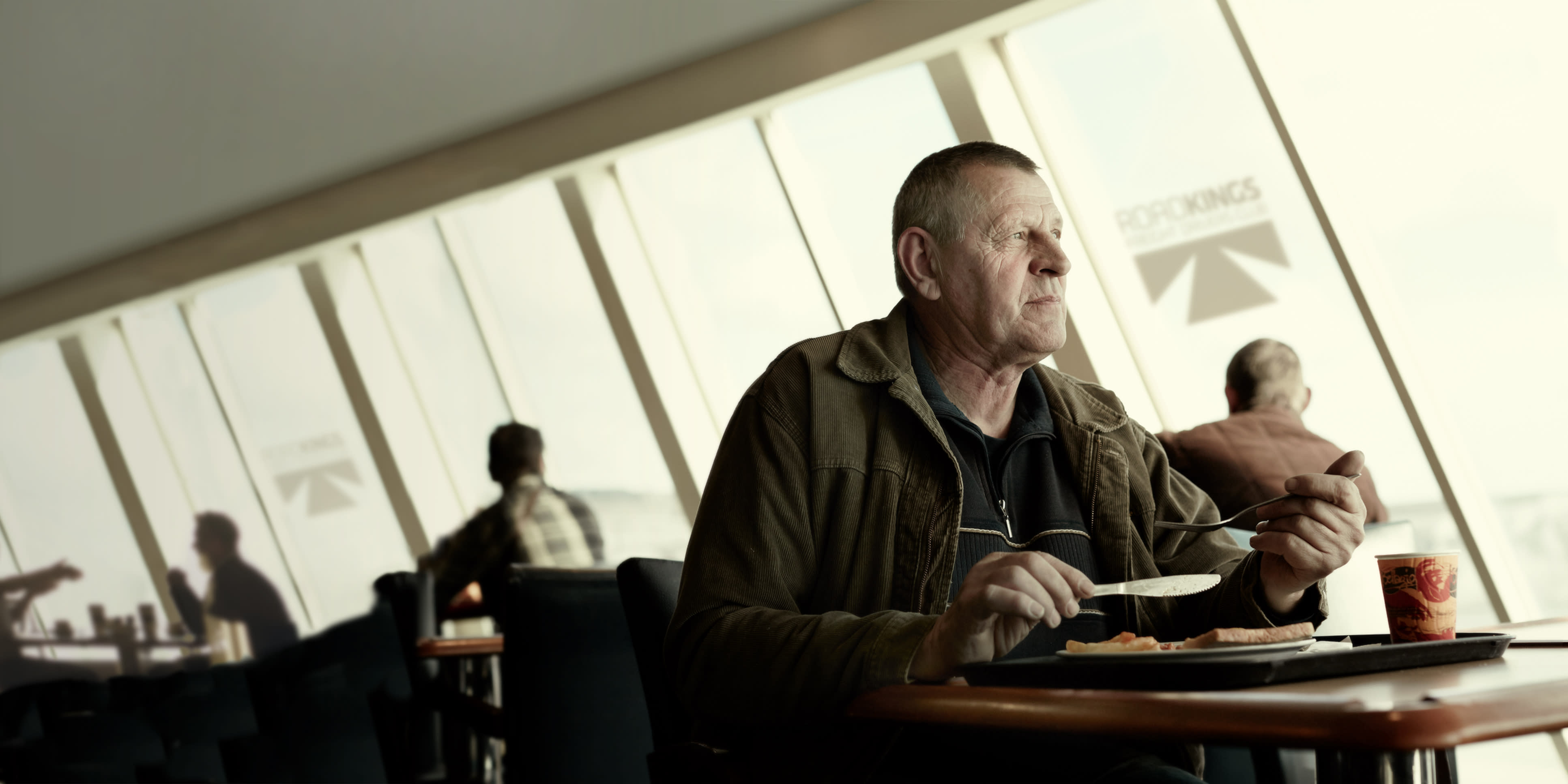 A freight driver enjoys his meal on board a DFDS ship road kings ship meal, cropped hero