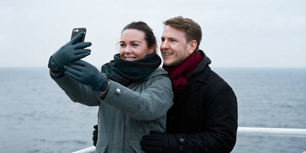 Couple taking selfie on deck - Promo