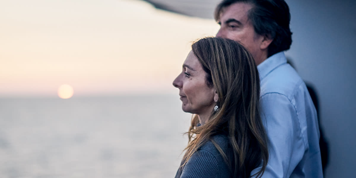 Couple watching the horizon on deck