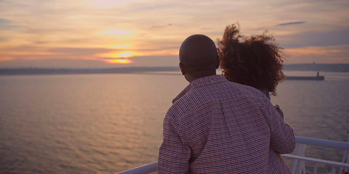 Couple looking at sunset on board of the Amsterdam-Newcastle ferry Couple looking at sunset on board of the Amsterdam-Newcastle ferry