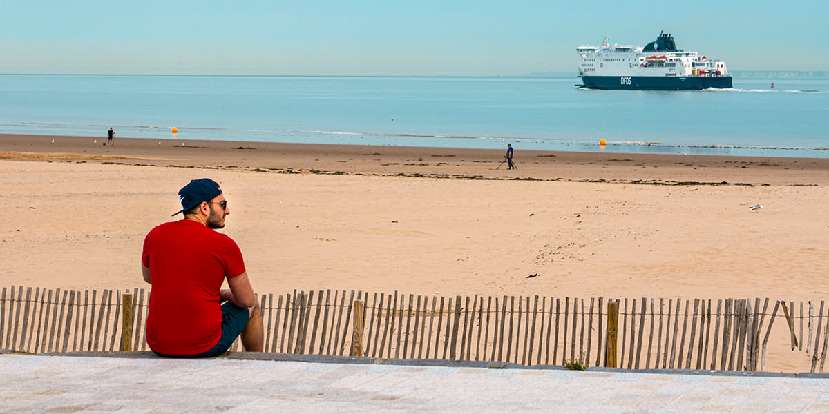 Calais beach with a DFDS ship