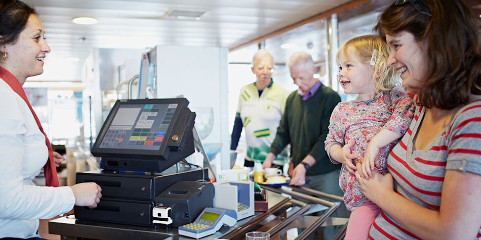 Woman with small child paying for food.
