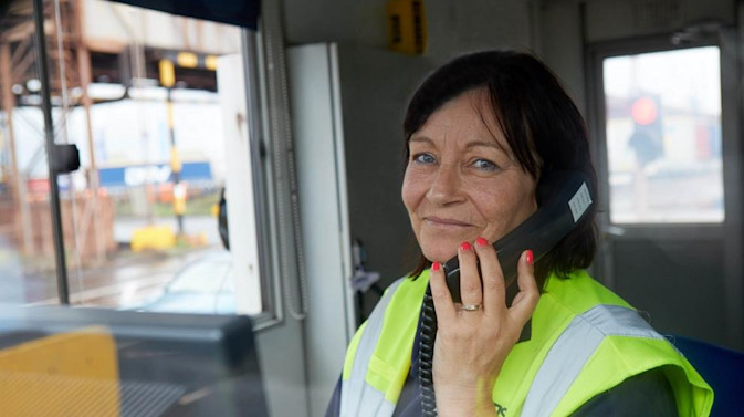 DFDS employee on the phone in a shipyard control tower