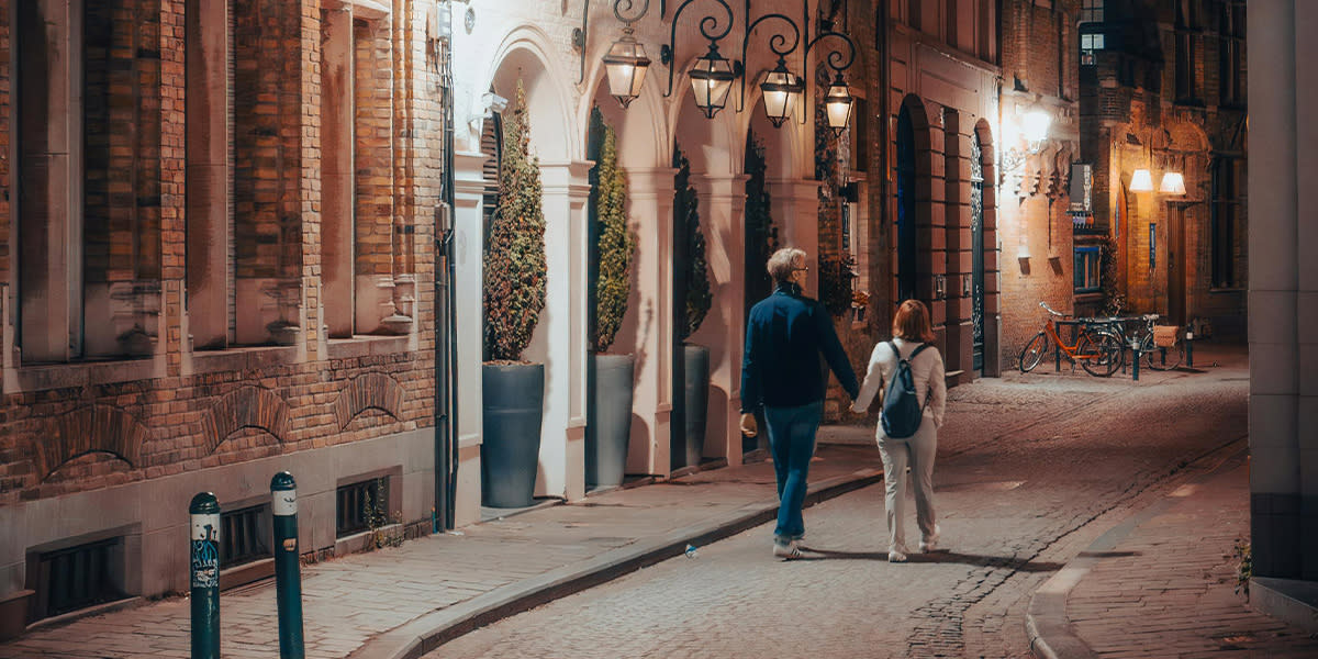 Couple walking down street in city