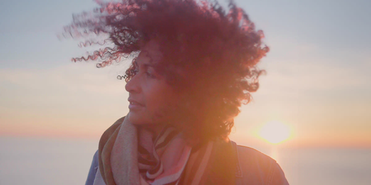 Woman enjoying fresh air on deck - promo