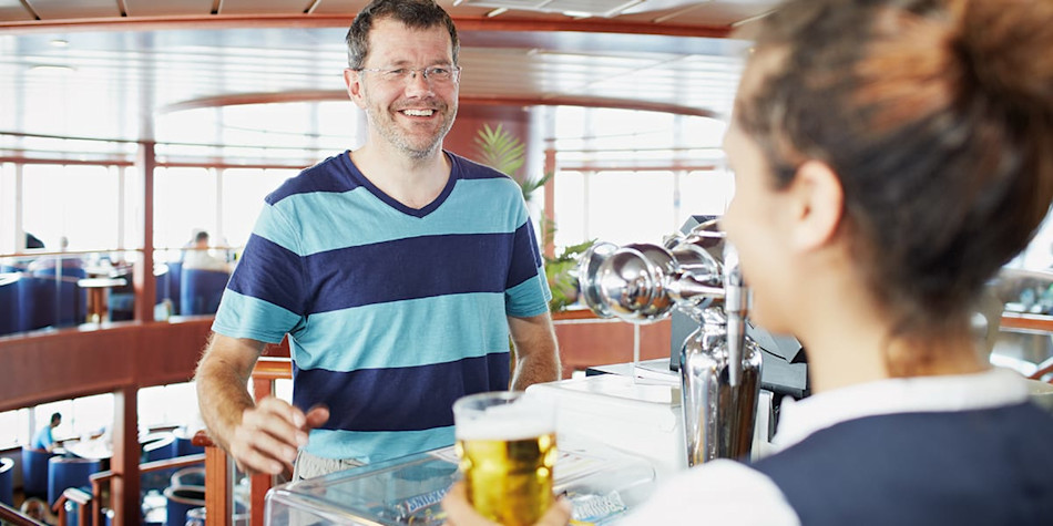 Man ordering a beer on the bar onboard DFDS Newhaven- Dieppe Transmache ferry.