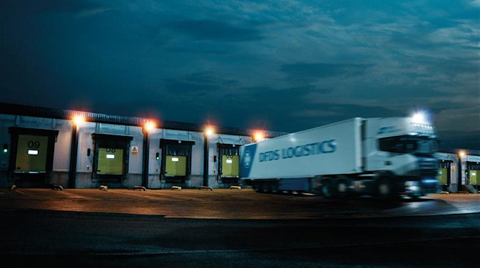 A DFDS logistics truck leaving a DFDS warehouse