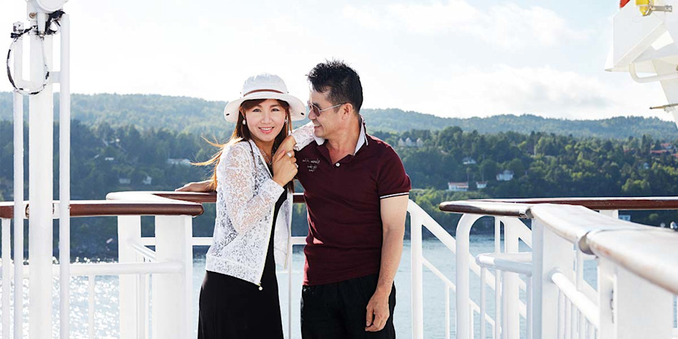A couple making a toast with their glass of wine.