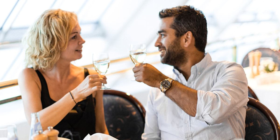 A couple making a toast with their glass of wine. 