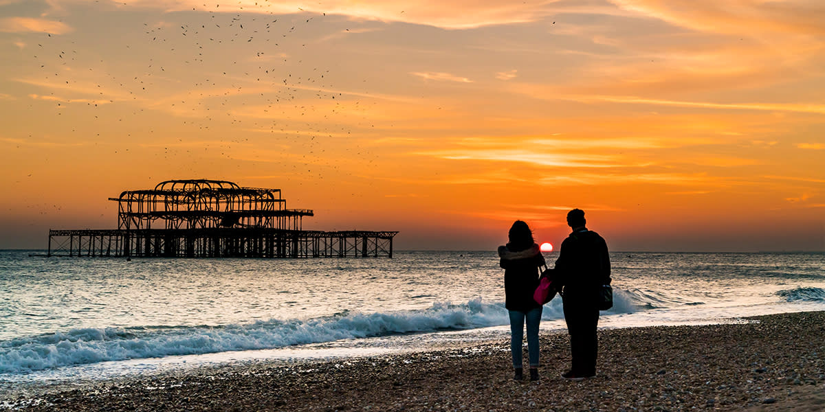 Couple looking at the sunset in Brighton