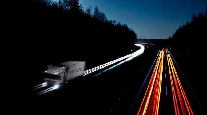 Long exposure image of a DFDS truck on a road at night