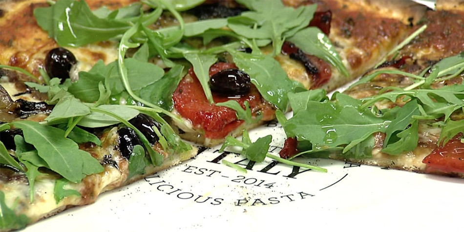 Thin oven baked pizza fresh out of the oven.