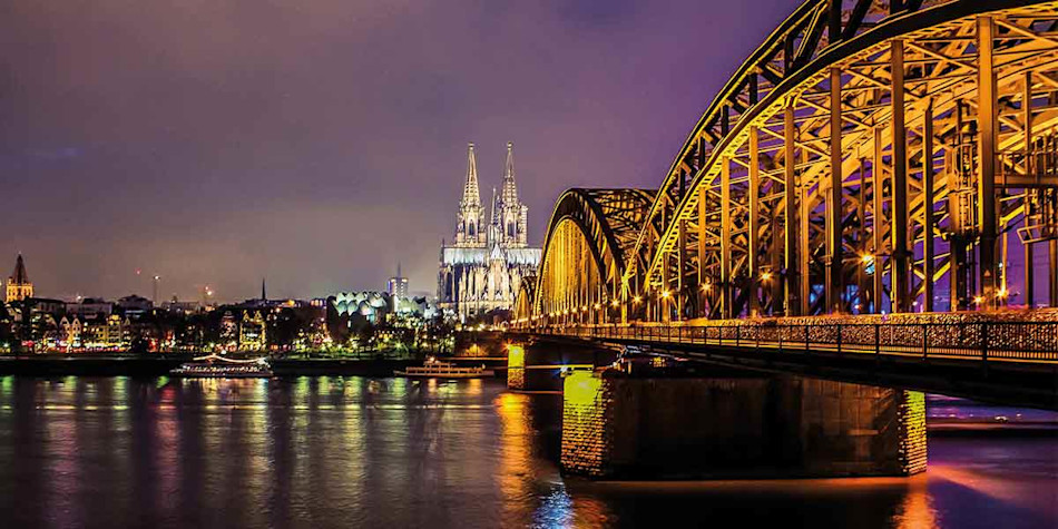 Bridge lit up at night in Cologne 