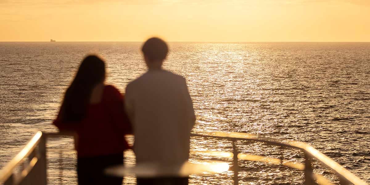 Couple looking at view from deck - promo