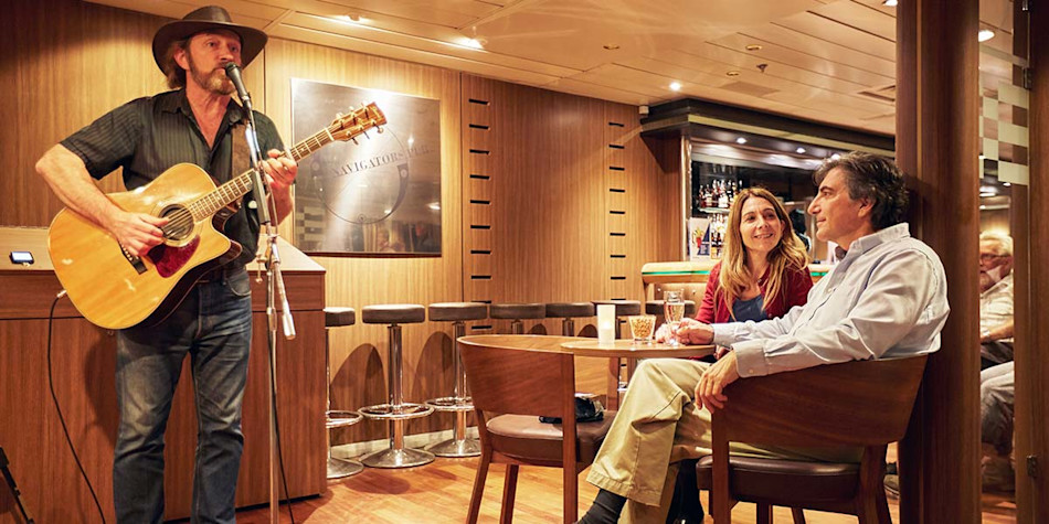 Man performing live entertainment onboard 