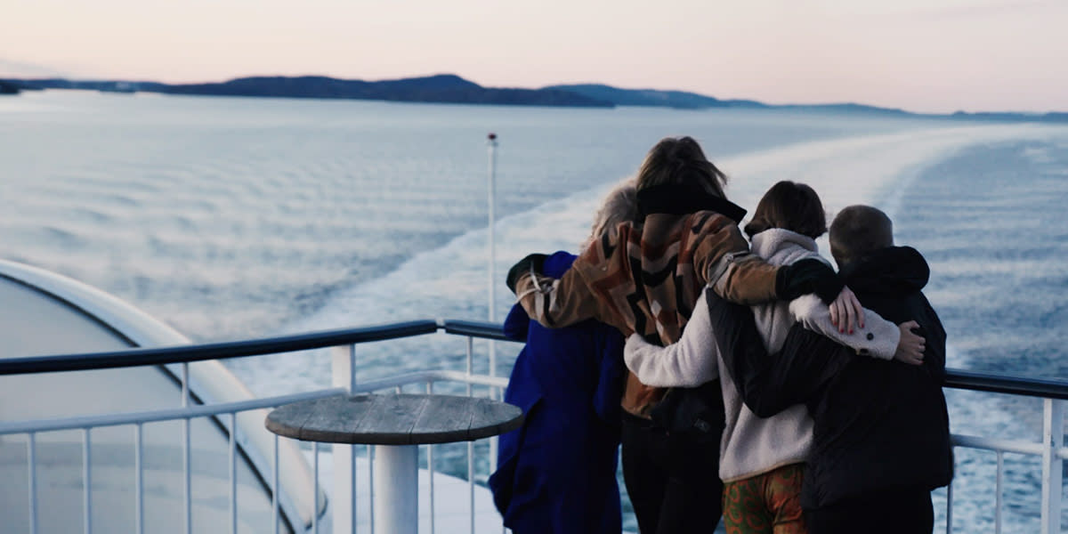 A family hugging onboard Hero 