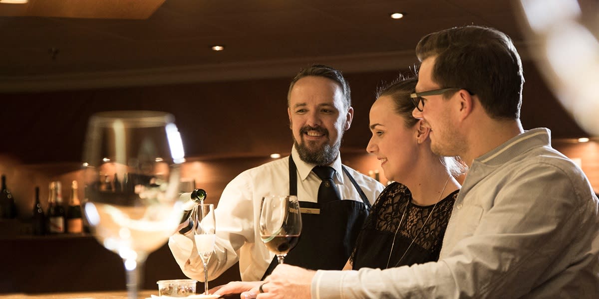 Couple and sommelier in Red and White winebar Couple and sommelier in Red and White winebar