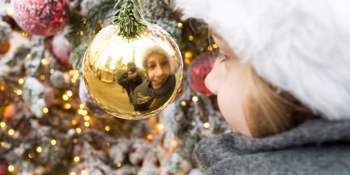 Girl reflected in a Christmas ball