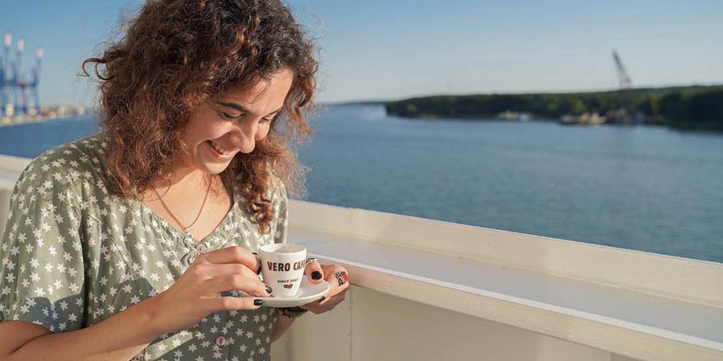 Woman drinking coffee on deck