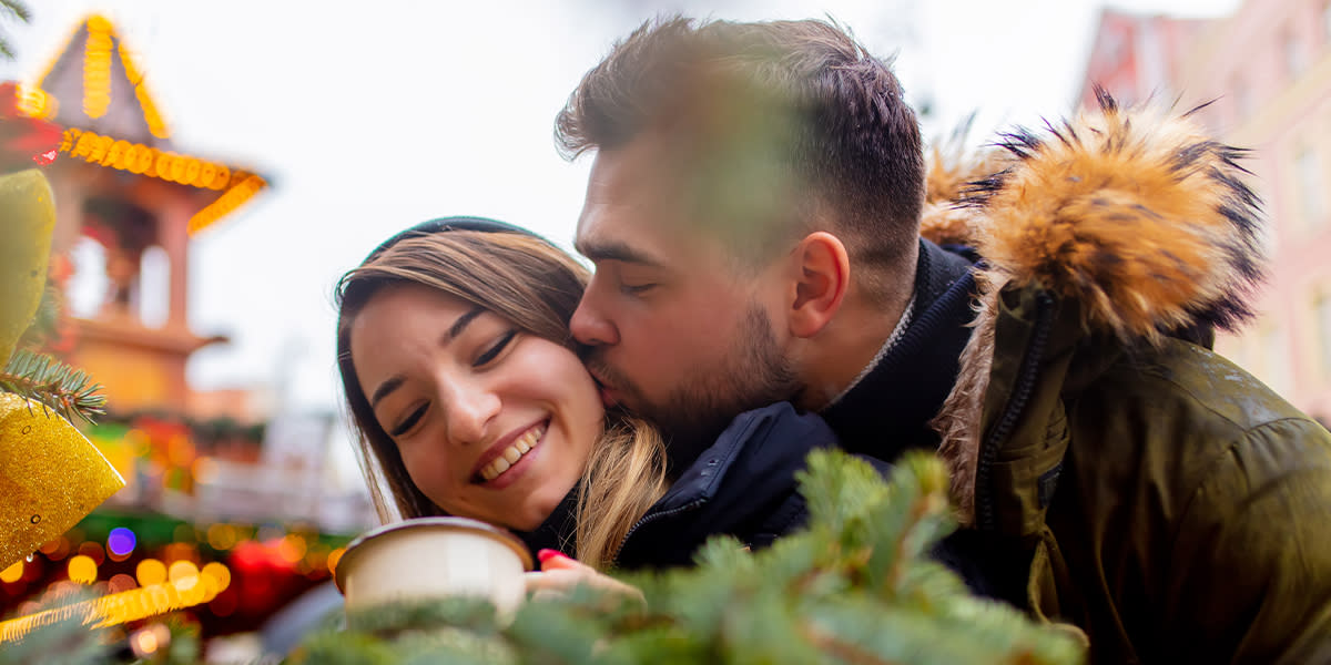 Couple kissing Christmas market