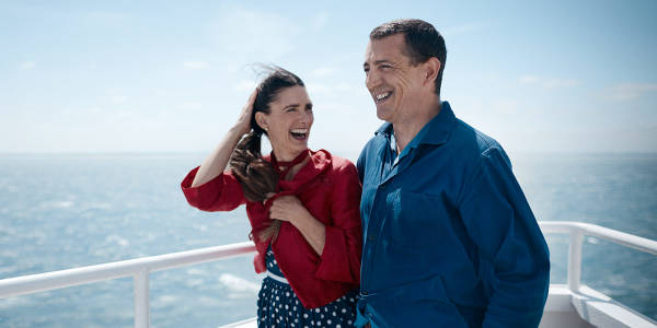 Couple laughing on deck promo