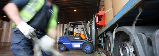 DFDS Logistics warehouse employees loading a truck, cropped image