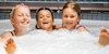 Three children playing together in an onboard Jacuzzi 