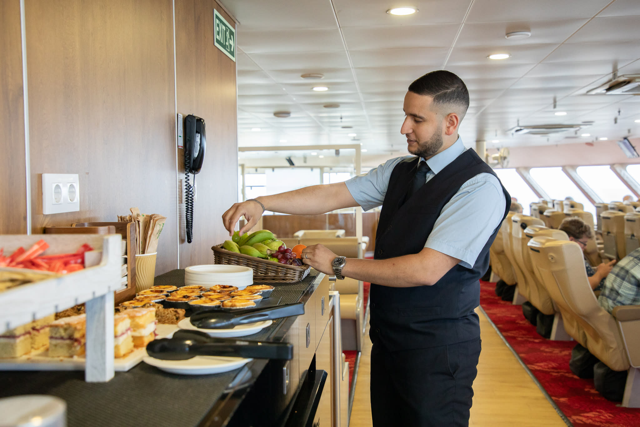 DFDS staff member restocking the Premium lounge on Poole - Jersey DFDS staff member restocking the Premium lounge on Poole - Jersey