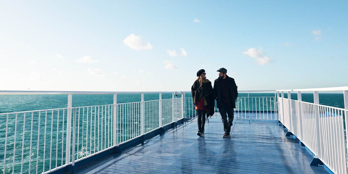 Couple onboard holding hands