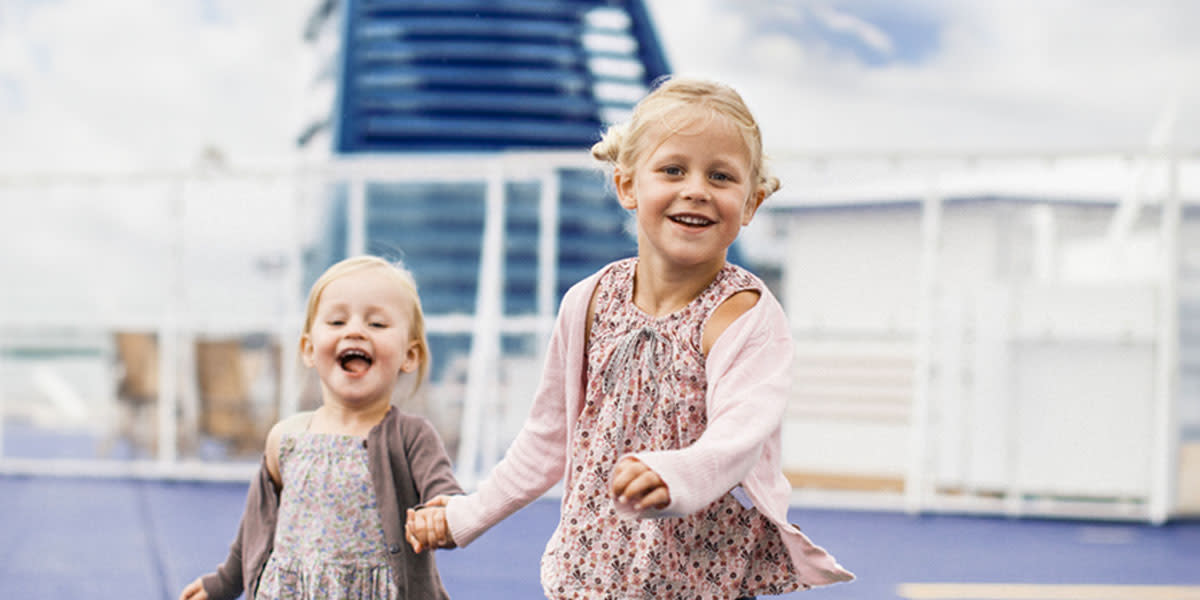 Two children holding hands on deck Promo
