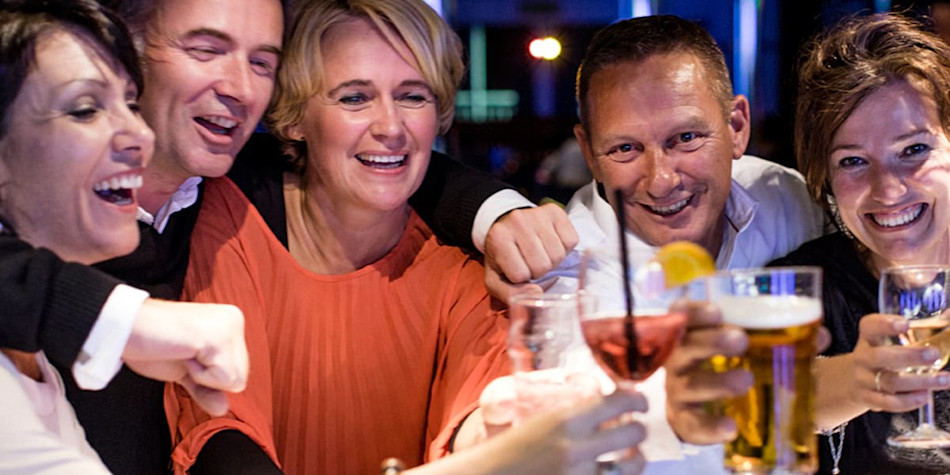 Friends making a toast with drinks onboard
