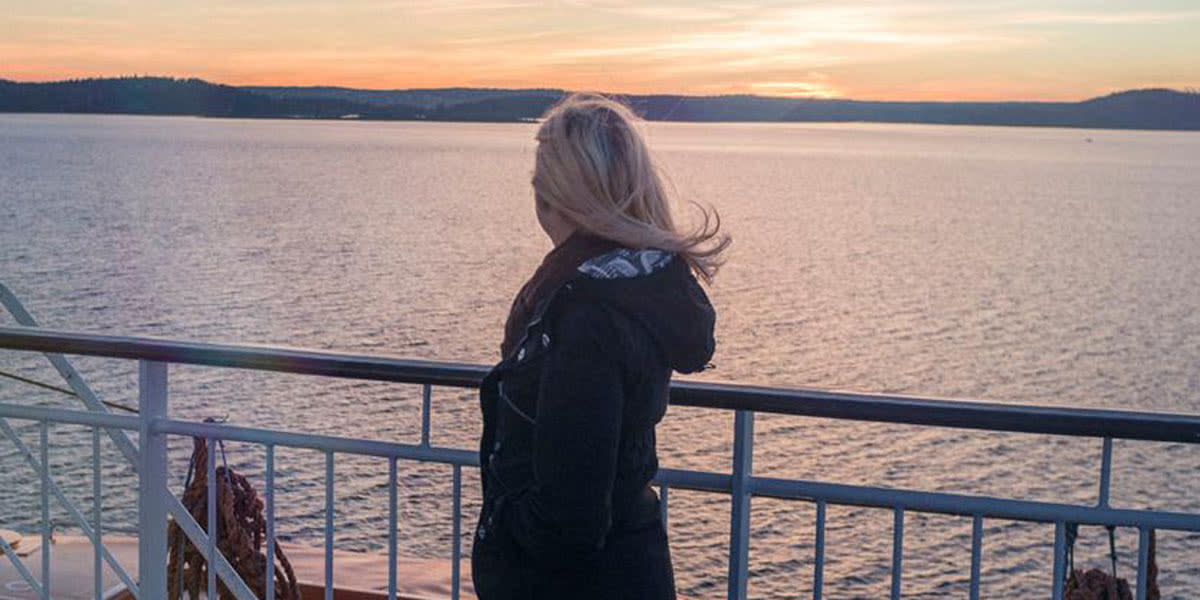 Woman on deck with sun 