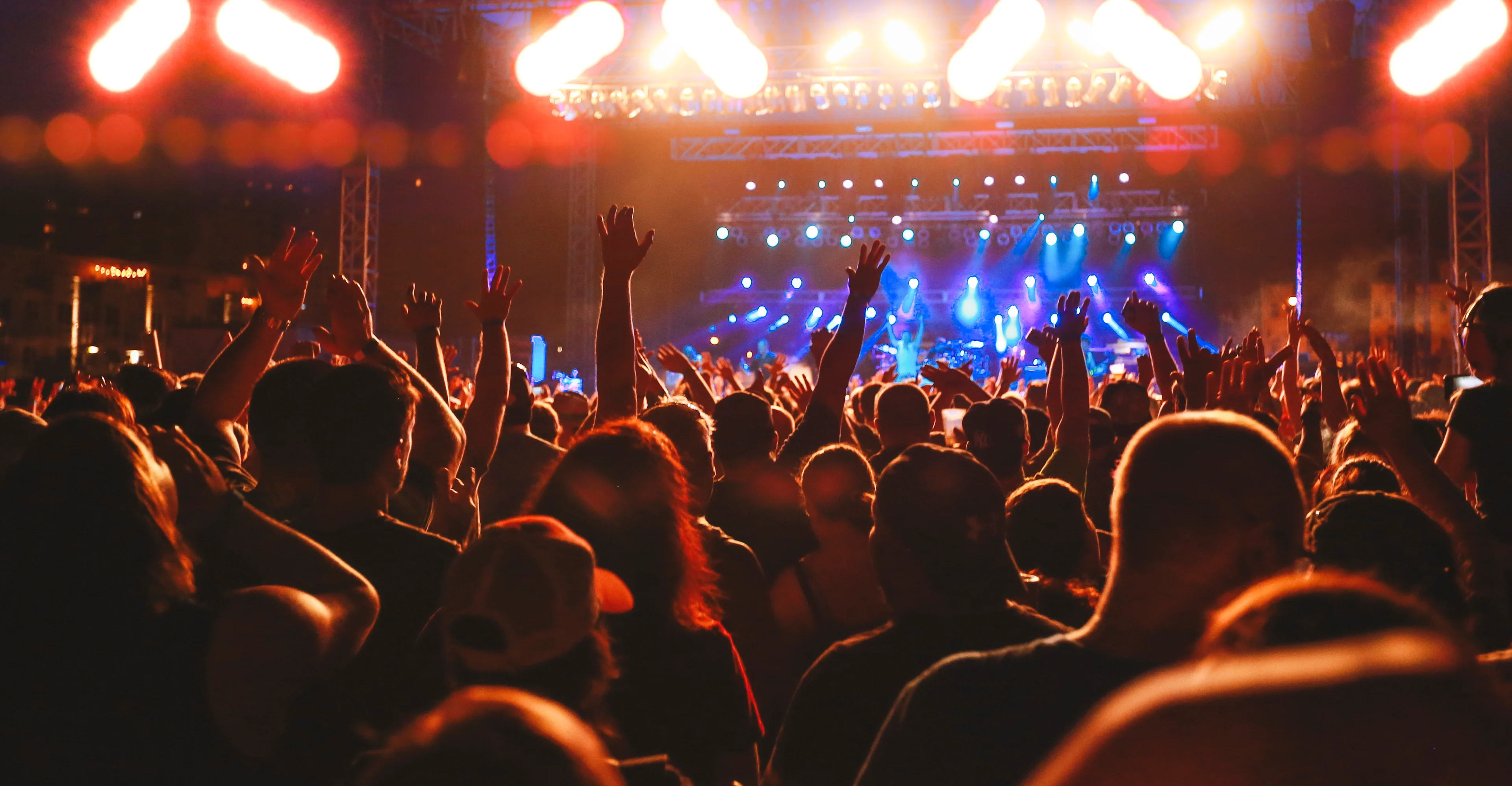 Concert Crowd Arms Raised, Audience Cheering, Live Music Event