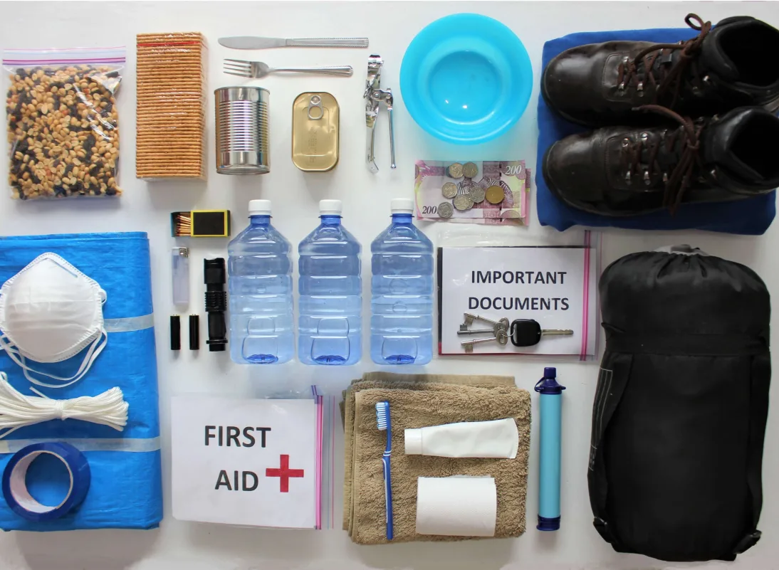Emergency supply kit with water, flashlight and first aid