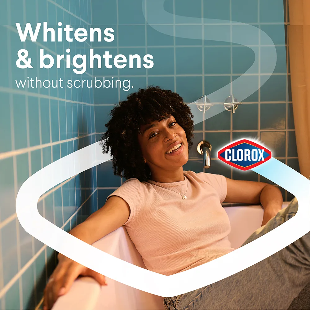 Woman sitting in a bathtub. Text says "Whitens & brightens without scrubbing."